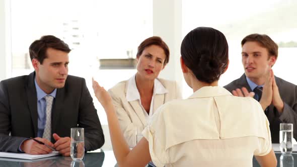 Businesswoman Being Interviewed By Unsure Panel