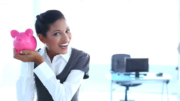 Businesswoman Checking Piggy Bank alt