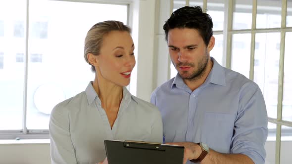 Young Attractive Colleagues Working Together On A Tablet