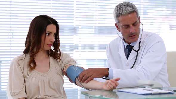 Doctor Checking Blood Pressure Of His Patient