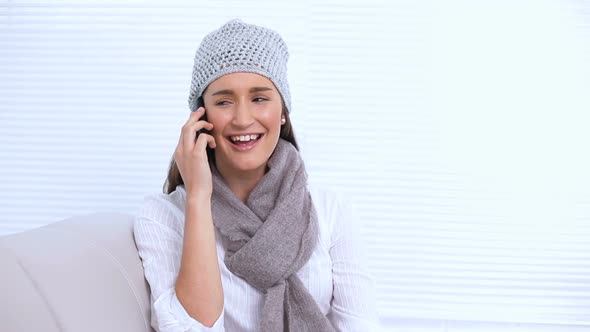 Smiling Young Woman With Hat And Scarf Calling Someone