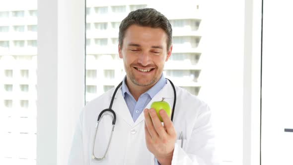 Doctor Holding A Green Apple
