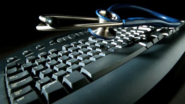 Blue Stethoscope Bouncing After Fall Onto Computer Keyboard