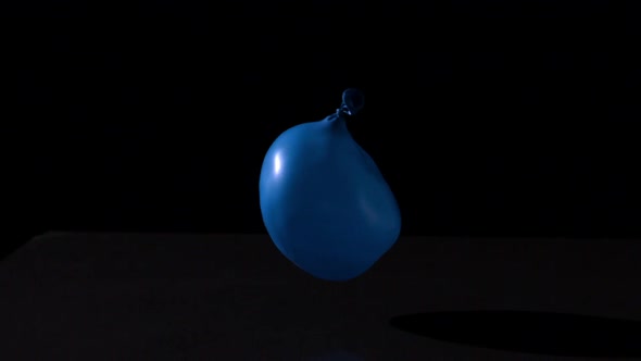 Blue Water Balloon Falling On Black Background