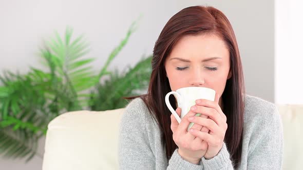 Pretty Young Woman Enjoying Coffee