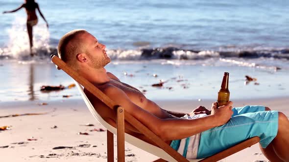 Young Man Sitting On The Beach