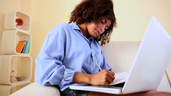 Gorgeous Happy Student Sitting On Couch Studying