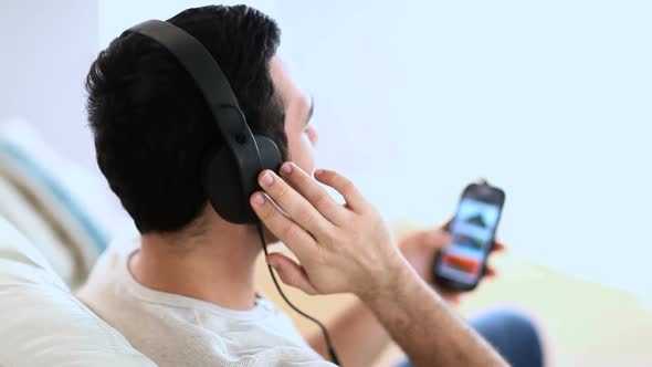 Cheerful Man Listening To Music With His Phone