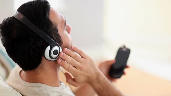 Man Enjoying Music On The Couch alt