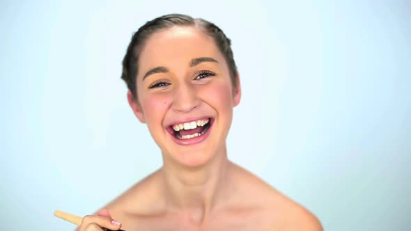 Young Woman Applying Brush For Her Make Up