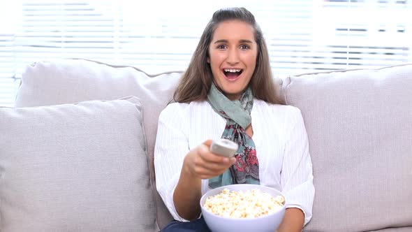 Brunette Watching Television And Eating Popcorn alt