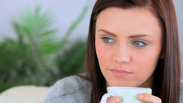 Brunette Woman Holding A Cup Of Coffee