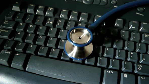 Stethoscope Falling Onto Computer Keyboard alt