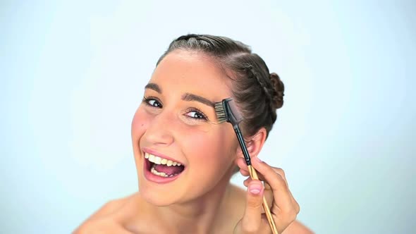 Young Woman Brushing Her Eyebrow alt