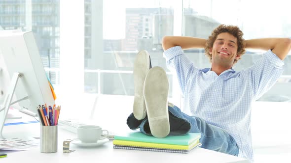 Relaxed Businessman Reclining On His Swivel Chair