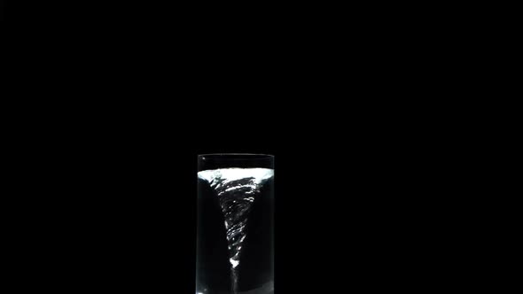 Whirlpool In Glass Of Water On Black Surface