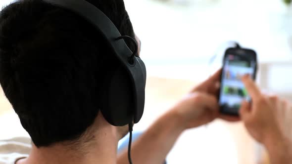 Man Moving His Head While Listening To Music With His Phone