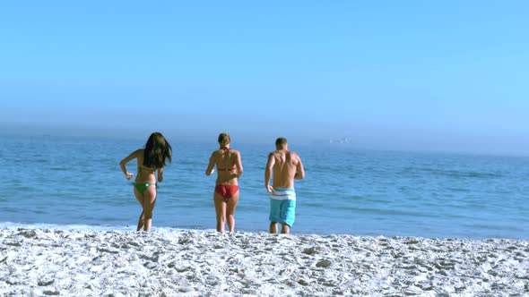 Group Of Friends Running Towards The Sea