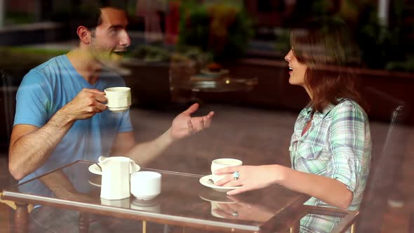 Student Couple Chatting Together In The Canteen Having Coffee