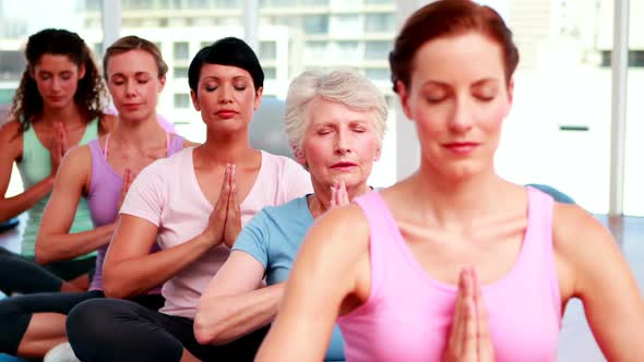 Group Of Peaceful Women In Fitness Studio Doing Yoga