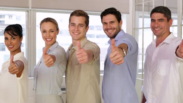 Attractive Businesspeople Posing Showing Thumbs Up