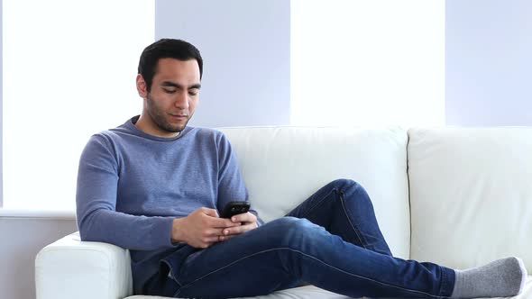 Man Text Messaging On The Couch
