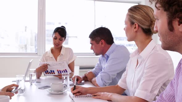 Attractive Businesswoman Presenting A Chart To Business Team