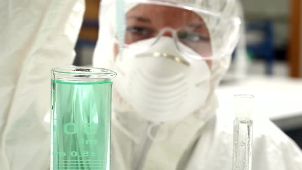 Science Student In Protective Suit Working With Chemicals