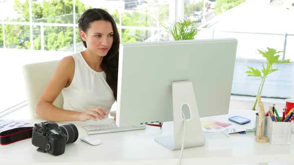 Attractive Businesswoman Working Concentrated At Her Desk