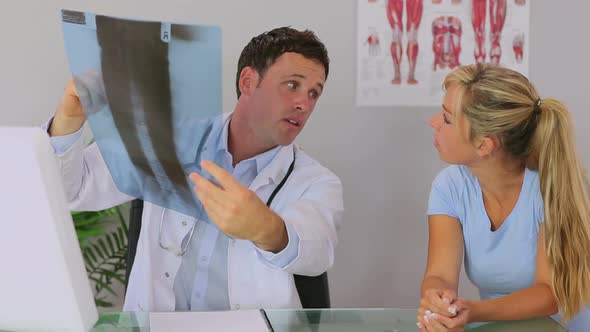 Chiropractor Discussing With His Patient