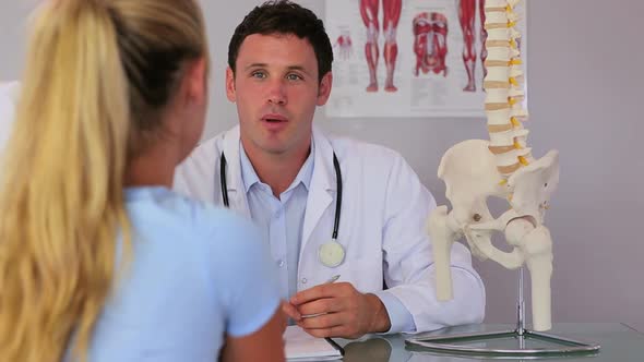 Chiropractor Speaking With His Patient