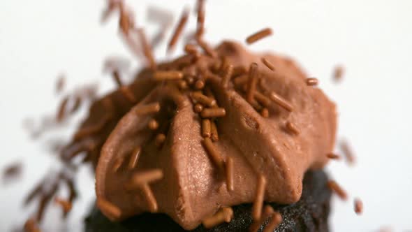 Chocolate Sprinkles Falling Onto Chocolate Cupcake