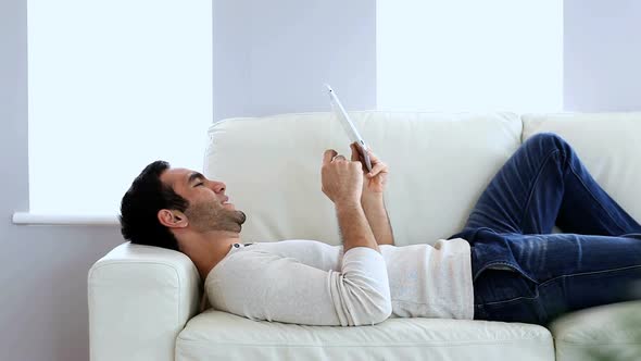 Man Using A Tablet Pc On The Couch