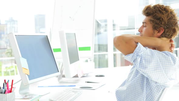 Exhausted Businessman Sitting On The Swivel Chair