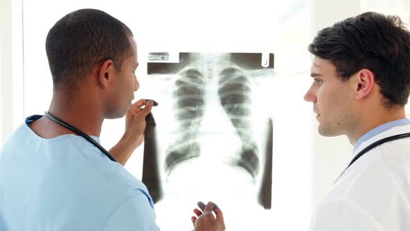 Surgeon And Doctor Looking Over Xray Together alt