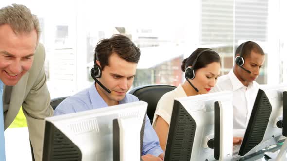 Manager Checking On Call Centre Employees alt