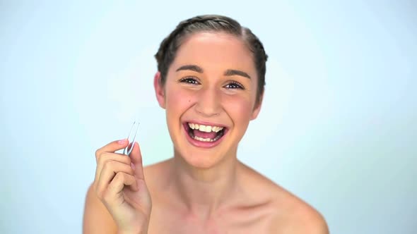 Young Woman Using Tweezers