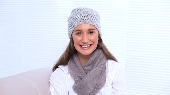 Young Woman Watching Television And Changing Channel