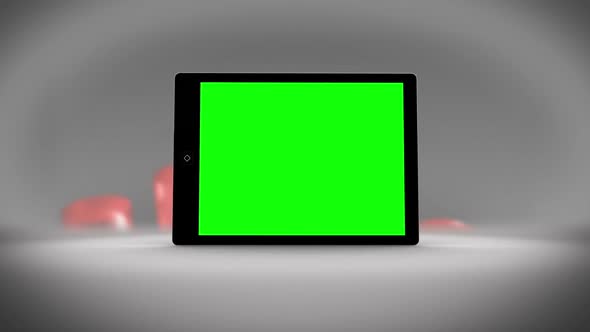 Tablet With Green Screen In Front Of Statistics