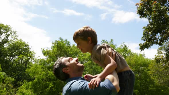 Father And Son Playing Together In The Park