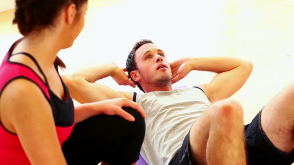 Attractive Toned Man Doing Situps Lying On Floor alt