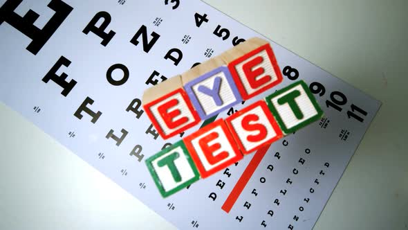 Colorful Blocks Spelling Out Eye Test Falling Onto Eye Test