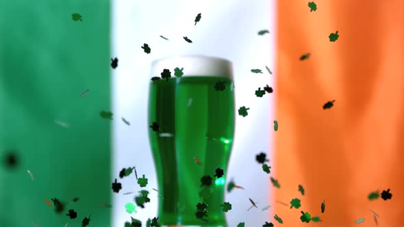 Shamrock Confetti Falling Beside Pint Of Green Beer