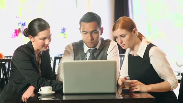 Business People Working Together While Having Coffee In A Restaurant