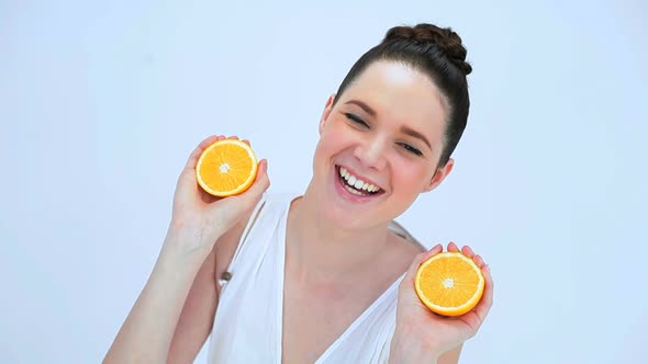 Attractive Woman Holding Slices Of Orange alt