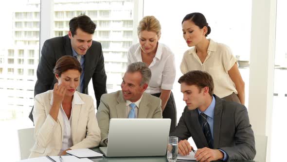 Business Team Discussing Something On The Laptop alt