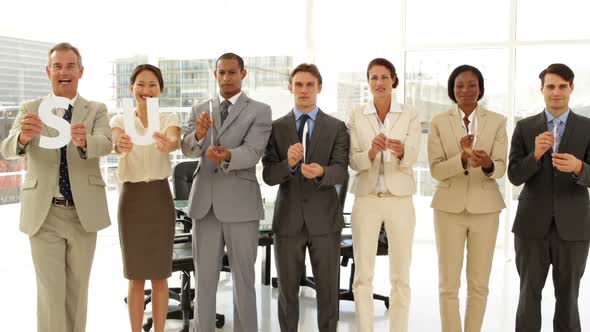 Happy Business People Holding Letters Spelling Success alt