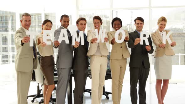 Happy Business People Holding Letters Spelling Teamwork