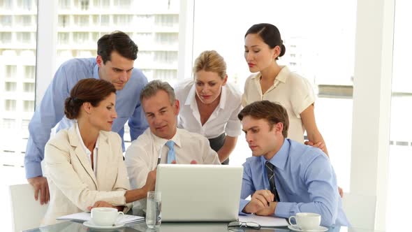 Happy Business Team Working In Front Of Laptop