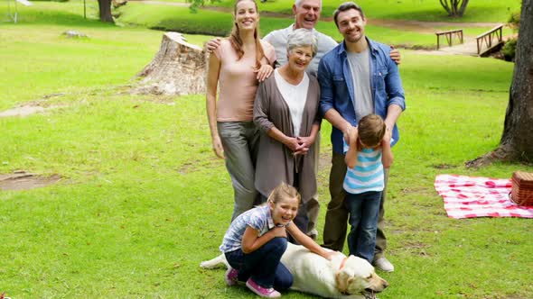 Multi Generation Family Smiling At Camera In A Park